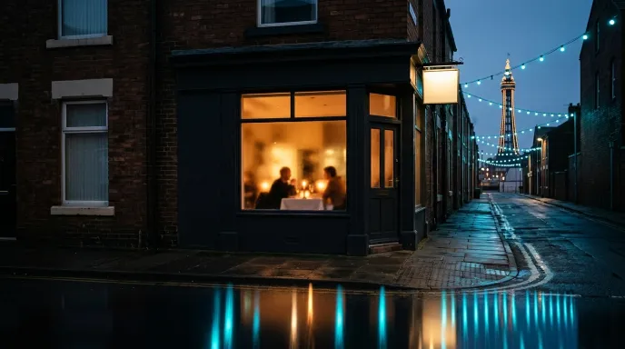 A warmly lit corner restaurant on a rainy Blackpool street at dusk, the Tower and illuminations glowing behind